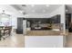 Modern kitchen with black cabinetry, stainless steel appliances, granite countertops, and tile backsplash at 4115 S 75Th Dr, Phoenix, AZ 85043
