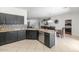 Open kitchen layout with dark cabinetry, granite countertops, a tile backsplash and dining area views at 4115 S 75Th Dr, Phoenix, AZ 85043