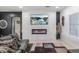 Modern living room with a sleek fireplace, stone accent wall, and stylish decor at 4115 S 75Th Dr, Phoenix, AZ 85043