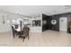 Spacious living area features tile flooring, a dining table, and views into the kitchen and outdoor pool area at 4115 S 75Th Dr, Phoenix, AZ 85043