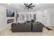 Open-concept living area with a ceiling fan, fireplace, and comfortable seating at 4115 S 75Th Dr, Phoenix, AZ 85043