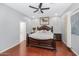 Spacious main bedroom features wood floors, a ceiling fan, a decorative headboard and ensuite at 4115 S 75Th Dr, Phoenix, AZ 85043