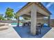 Covered outdoor patio with built-in barbecue, seating area, and view of the pool at 4115 S 75Th Dr, Phoenix, AZ 85043
