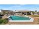Inviting backyard oasis with a sparkling pool, outdoor kitchen, fire pit, and ample patio space for entertaining at 4115 S 75Th Dr, Phoenix, AZ 85043