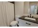 Clean bathroom features a shower with new curtain, and vanity with modern dark gray countertops at 4238 W Krall St, Phoenix, AZ 85019