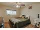 Comfortable bedroom with a ceiling fan and large window, creating a restful and relaxing space at 4238 W Krall St, Phoenix, AZ 85019