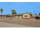 Charming single-story brick home featuring a well-lit entry and low-maintenance gravel landscaping at 4238 W Krall St, Phoenix, AZ 85019