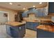 Well-appointed kitchen with blue cabinets, butcher block countertops, and stainless steel appliances at 4238 W Krall St, Phoenix, AZ 85019