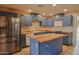 Modern kitchen with stylish blue cabinets, butcher block countertops, and stainless steel refrigerator at 4238 W Krall St, Phoenix, AZ 85019