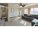 Inviting living room with plush carpeting, ceiling fan, and ample natural light from large windows at 4238 W Krall St, Phoenix, AZ 85019