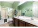 Bathroom with double sinks, framed mirror and shower with glass doors at 45140 W Zion Rd, Maricopa, AZ 85139