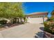 Charming single-story home with a well-kept front lawn and a spacious two-car garage at 45140 W Zion Rd, Maricopa, AZ 85139