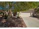 Tan home with a well manicured front yard and a two-car garage at 45140 W Zion Rd, Maricopa, AZ 85139