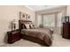 Comfortable main bedroom with a bay window, neutral walls, and carpeted floors at 45140 W Zion Rd, Maricopa, AZ 85139