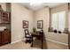Home office featuring a wooden desk and chair, and a built-in cabinet and window seat at 45140 W Zion Rd, Maricopa, AZ 85139