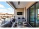 Inviting outdoor balcony featuring stylish seating and a mounted TV for ultimate relaxation and entertainment at 5250 E Deer Valley Dr # 243, Phoenix, AZ 85054