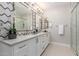 Elegant bathroom boasts dual sinks, modern lighting, decorative backsplash, and a glass-enclosed shower at 5250 E Deer Valley Dr # 243, Phoenix, AZ 85054
