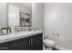Stylish powder room featuring dark cabinetry, quartz countertops, and modern finishes at 5250 E Deer Valley Dr # 243, Phoenix, AZ 85054