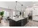 Open-concept kitchen with a large island, stainless steel appliances and a dining area at 5250 E Deer Valley Dr # 243, Phoenix, AZ 85054