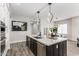 Modern kitchen featuring an island, quartz countertops, stainless steel appliances, and pendant lighting at 5250 E Deer Valley Dr # 243, Phoenix, AZ 85054