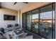 Inviting outdoor patio with comfortable seating, a TV, and sliding glass doors at 5250 E Deer Valley Dr # 243, Phoenix, AZ 85054