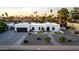 Expansive aerial view of the property showcasing the home, landscaping, and surrounding neighborhood at 5642 E Justine Rd, Scottsdale, AZ 85254