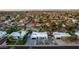 Aerial view of a home and neighborhood featuring mature landscaping, various home styles, and views of the surrounding community at 5642 E Justine Rd, Scottsdale, AZ 85254