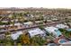 Birds-eye view of a neighborhood, highlighting varied architectural styles and beautiful yards with sparkling swimming pools at 5642 E Justine Rd, Scottsdale, AZ 85254