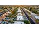 High-angle shot of a quiet, tree-lined street featuring diverse home styles, well-kept yards, and neighborhood charm at 5642 E Justine Rd, Scottsdale, AZ 85254