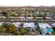 Expansive aerial view of a residential neighborhood showcasing homes and a community pool, surrounded by lush landscaping and desert mountains at 5642 E Justine Rd, Scottsdale, AZ 85254