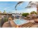 Expansive backyard with a pool, hot tub, patio furniture, and lush landscaping with a mix of desert plants and palm trees at 5642 E Justine Rd, Scottsdale, AZ 85254