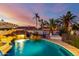 Swimming pool with waterfall feature, lounge chairs, sun umbrellas, and desert landscaping creates a tranquil atmosphere at 5642 E Justine Rd, Scottsdale, AZ 85254