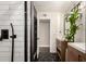 Bathroom with dark accent wall, a shower, and a wood vanity with a white countertop at 5642 E Justine Rd, Scottsdale, AZ 85254