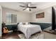 This bedroom features a ceiling fan and neutral paint with teal accent wall at 5642 E Justine Rd, Scottsdale, AZ 85254