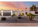 Beautiful single-story home with desert landscaping and a view of the sunset sky at 5642 E Justine Rd, Scottsdale, AZ 85254