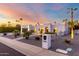 Stunning exterior view of home with desert landscaping, palm trees, and blue hour sky at 5642 E Justine Rd, Scottsdale, AZ 85254