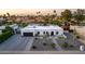 Expansive single-story home featuring desert landscaping, a paver driveway, and a large garage at 5642 E Justine Rd, Scottsdale, AZ 85254