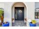 Inviting front door entrance with tiled porch, wooden benches, and stylish exterior lighting at 5642 E Justine Rd, Scottsdale, AZ 85254