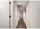Long hallway with multiple closets, recessed lighting, and dark wood floors at 5642 E Justine Rd, Scottsdale, AZ 85254
