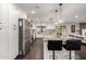 Bright kitchen features granite countertops, island with seating, stainless appliances, and dark wood flooring at 5642 E Justine Rd, Scottsdale, AZ 85254