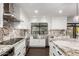 Kitchen with granite countertops, stainless steel appliances, farmhouse sink, and dark wood floors at 5642 E Justine Rd, Scottsdale, AZ 85254