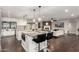 Open floor plan with kitchen island seating, granite countertops, and brick fireplace in the living room at 5642 E Justine Rd, Scottsdale, AZ 85254