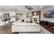 Open-concept living area featuring fireplace, wood accent wall, ceiling fan, and view of the kitchen at 5642 E Justine Rd, Scottsdale, AZ 85254