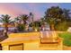 Outdoor kitchen with built-in grill, fridge, and lush landscaping creating a tranquil outdoor oasis at 5642 E Justine Rd, Scottsdale, AZ 85254