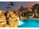 Backyard pool with waterfall, spa, and desert landscaping at dusk at 5642 E Justine Rd, Scottsdale, AZ 85254