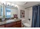 Cozy bathroom featuring a granite countertop vanity, framed mirror, and shower and tub combination at 5877 N Granite Reef Rd # 1155, Scottsdale, AZ 85250