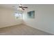 Neutral bedroom with a ceiling fan, carpet flooring, and a window providing natural light at 5877 N Granite Reef Rd # 1155, Scottsdale, AZ 85250