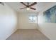 Cozy bedroom featuring a ceiling fan, carpet flooring, and a view of the outdoors from the window at 5877 N Granite Reef Rd # 1155, Scottsdale, AZ 85250