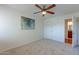 Carpeted bedroom with ceiling fan and an open door to a bathroom at 5877 N Granite Reef Rd # 1155, Scottsdale, AZ 85250