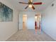 Carpeted bedroom featuring two open doors to a bathroom and a walk-in closet at 5877 N Granite Reef Rd # 1155, Scottsdale, AZ 85250